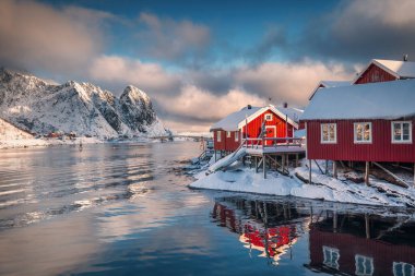 Lofoten Adaları, Reine, Norveç ve Hamnoy balıkçı köyleri. Kızıl ışıklı evleri ve kışın köprü. Doğa manzarası.