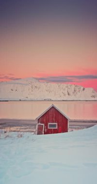Ramberg Kızıl Kulübesi ve Kuzey Denizi manzarası, Lofoten Adaları, Norveç Kış Deniz Burnu ve gökyüzünde kuzey ışıkları