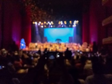 Tiyatro sahnesindeki gösterinin sonu arka planı ve izleyicileri bulanıklaştırdı 