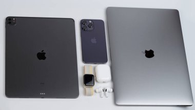 New York, ABD - 8 Kasım 2022: Birçok taşınabilir cihaz, iphone, saat ve kulaklık beyaz arka planda üst görünümde yatıyordu