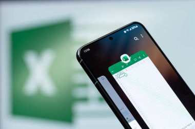 New York, ABD - 20 Ağustos 2023: Microsoft ofis üstün hizmet mobil uygulaması kullanarak akıllı telefon ekranı kapalı bulanık logo arka plan