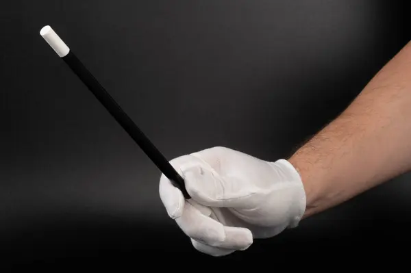 stock image Hand hold magic wizard wand close up view on black background