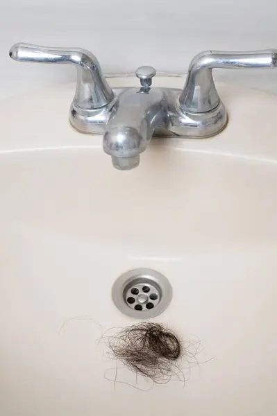 Stock image Messy clog hair in ceramic sink macro clsoe up view