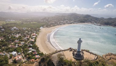 Jesus christ on hill Nicaragua in San Juan Del Sur aerial drone view  clipart