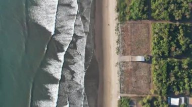 Üst dron görüntüsünün üzerinde hareket eden bir ATV ile temiz plaj