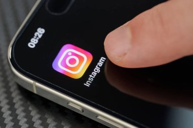 New York, ABD - 24 Ocak 2024: Parmağını iPhone 15 'te parmağıyla açık Instagram uygulama simgesine dokunmak