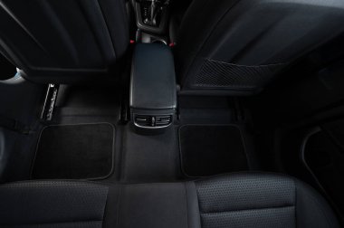 Araba zemininde, üst manzarası siyah paspaslı bir damat.