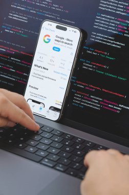 New York, ABD - 23 Şubat 2024: Dizüstü bilgisayarda elleri klavyede yeni Google uygulaması için kod