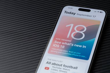 New York, USA - September 17, 2024: Updating iphone firmware to iOS 18 on screen macro close up view  clipart