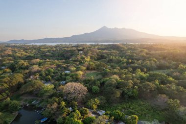 Adventure in Granada Nicaragua theme. Mombacho volcano in sunset light aerial drone view clipart