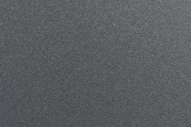 Kabartma görünümü ince tanelerden oluşmuş, ışığı güzel bir şekilde yakalayan desenli siyah bir yüzey sergiliyor..