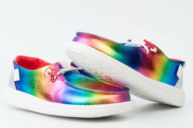 Vibrant rainbow shoes showcase reflective surface and modern design, perfect for adding flair to any outfit. clipart