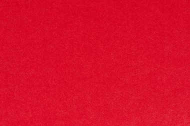 Pürüzsüz, dokulu yüzeyi yaratıcı projeler veya gösterimler için mükemmel olan canlı kırmızı arkaplan.
