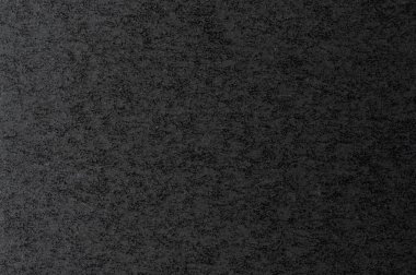 Koyu kağıdın yakın görüntüsü, desenli yüzey görüntüsü derinlik ve ilgi ekleyen karmaşık desenler ve tonlar.