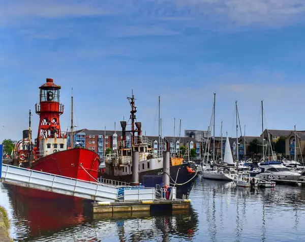 Galler 'deki Swansea Marina manzarası. Görüntü deniz feneri olan eski bir tekneyi gösteriyor.. 