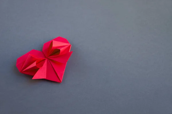 stock image Red paper heart origami isolated on a blank grey background. Valentines day card