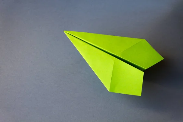 stock image Green paper plane origami isolated on a blank grey background