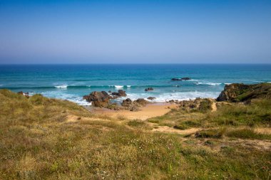 Beach and cliffs in Cantabria, Spain. Blue sky