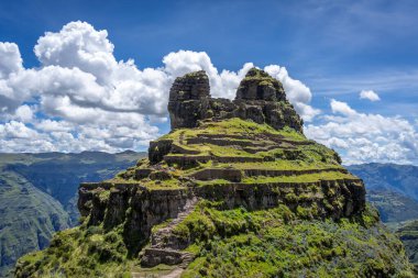 Peru 'daki Waqrapukara arkeolojik sahasında engebeli bir dağ zirvesinde, Andean manzarasının çarpıcı manzaralarını sunan teraslı taş kalıntıları yer almaktadır.