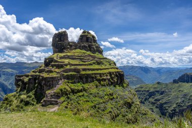 Peru 'daki Waqrapukara arkeolojik sahasında engebeli bir dağ zirvesinde, Andean manzarasının çarpıcı manzaralarını sunan teraslı taş kalıntıları yer almaktadır.