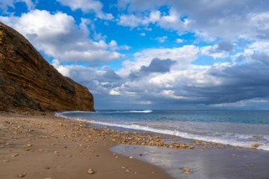 Avustralya 'nın Büyük Okyanus Yolu üzerindeki Aireys Körfezi' ndeki Bells Beach 'te altın kum, dağınık kayalar ve yüksek uçurumlar bulunur. Mavi okyanus dramatik bulutlarla dolu uçsuz bucaksız bir gökyüzü ile karşılaşıyor, çarpıcı bir kıyı manzarası yaratıyor.