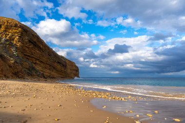 Avustralya 'nın Büyük Okyanus Yolu üzerindeki Aireys Körfezi' ndeki Bells Beach 'te altın kum, dağınık kayalar ve yüksek uçurumlar bulunur. Mavi okyanus dramatik bulutlarla dolu uçsuz bucaksız bir gökyüzü ile karşılaşıyor, çarpıcı bir kıyı manzarası yaratıyor.