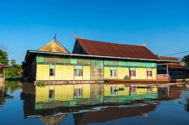 Parlak boyalı Bugis balıkçılarının evleri, Endonezya 'nın Sulawesi kentindeki geleneksel mimari ve günlük yaşamı yansıtan Tempe Gölü' nde huzur içinde yüzüyor.
