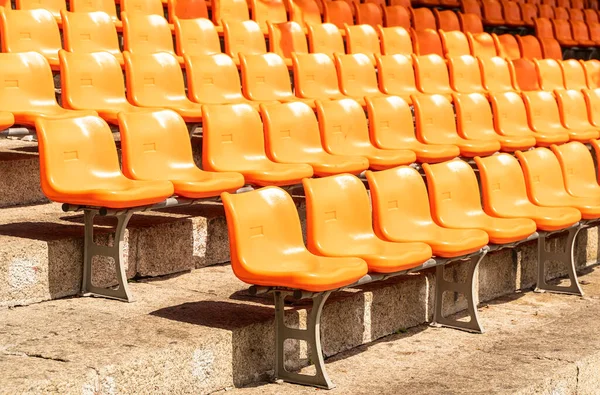 Empty orange seat of football stadium