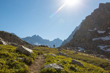 hiker in mountains on beautiful rock background