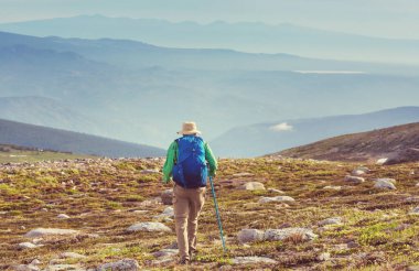 Hiker in beautiful mountains in Tombstone Territorial Park, Yukon, Canada