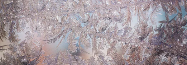 Frozen window. Crystals on a frozen window. Christmas background.