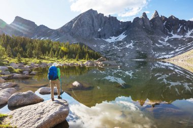 hiker in mountains on beautiful rock background