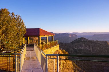 Man on the suspension bridge in Barrancas mountains, Mexico