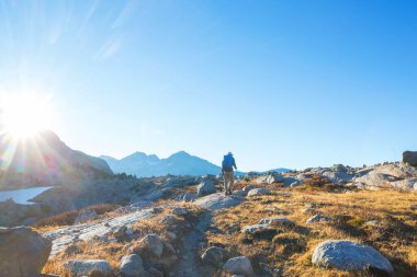hiker in mountains on beautiful rock background
