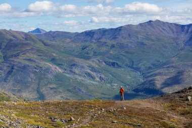 Hiker in beautiful mountains in Tombstone Territorial Park, Yukon, Canada