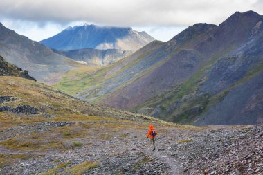 Hiker in beautiful mountains in Tombstone Territorial Park, Yukon, Canada
