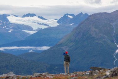 hiker in mountains on beautiful rock background