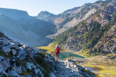 hiker in mountains on beautiful rock background