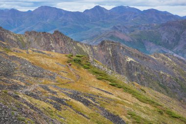 Hiker in beautiful mountains in Tombstone Territorial Park, Yukon, Canada