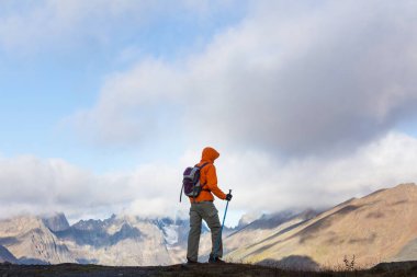 Hiker in beautiful mountains in Tombstone Territorial Park, Yukon, Canada