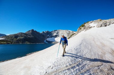 hiker in mountains on beautiful rock background