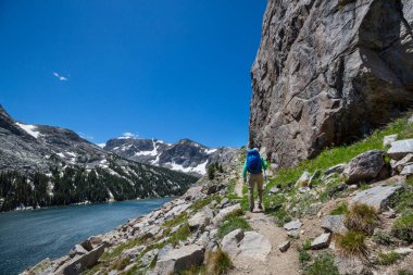 hiker in mountains on beautiful rock background