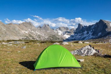 Hiking tent and backpacks in camping  in the mountains in summer season