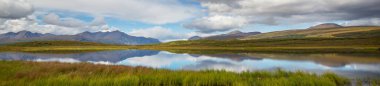 Beautiful blue lake in polar tundra along Dempster highway, Yukon, Canada