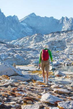 hiker in mountains on beautiful rock background