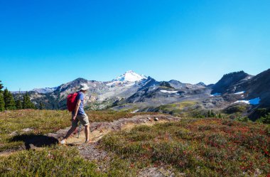 hiker in mountains on beautiful rock background