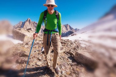 hiker in mountains on beautiful rock background