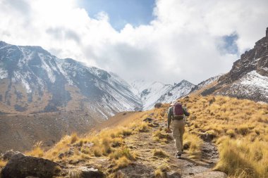 hiker in mountains on beautiful rock background