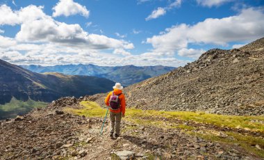 Hiker in beautiful mountains in Tombstone Territorial Park, Yukon, Canada