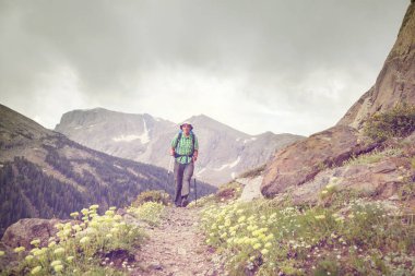 hiker in mountains on beautiful rock background